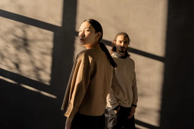 Two people in wool knitwear in low sunlight