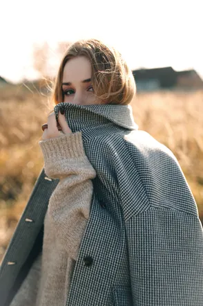 Woman wrapped in a houndstooth wool coat